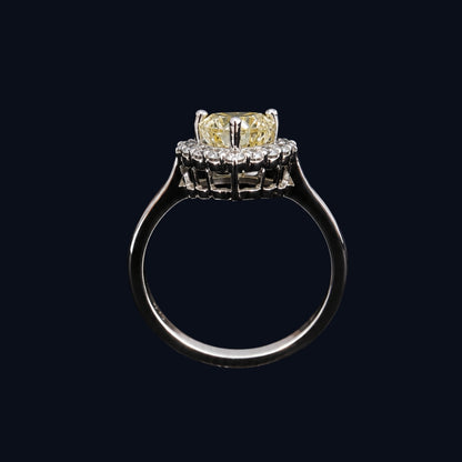 A silver ring with a large CZ stone and smaller CZ stones around it, set against a dark background.