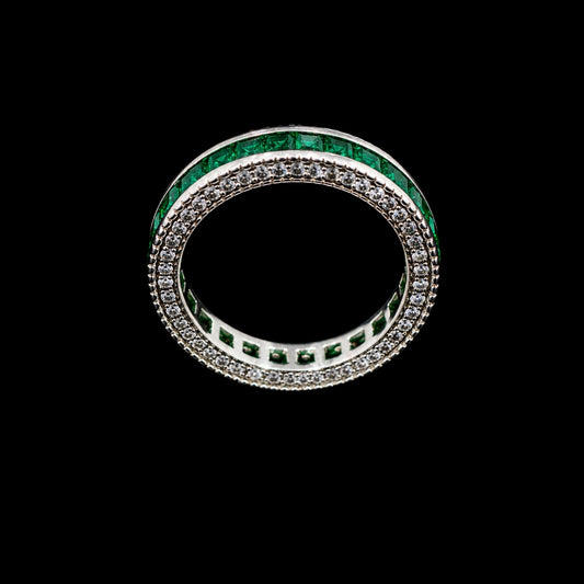 A silver-tone ring with a double row of emerald green and clear CZ stones.