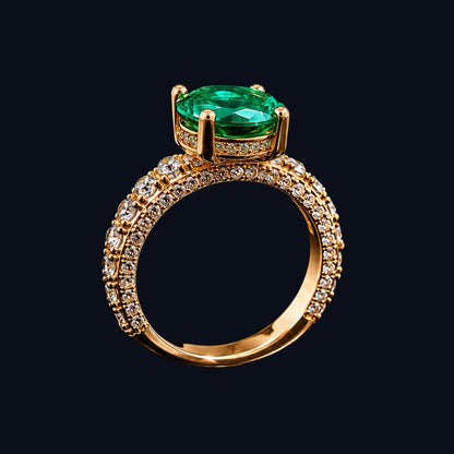 A gold-tone ring with an emerald stone and CZ details.
