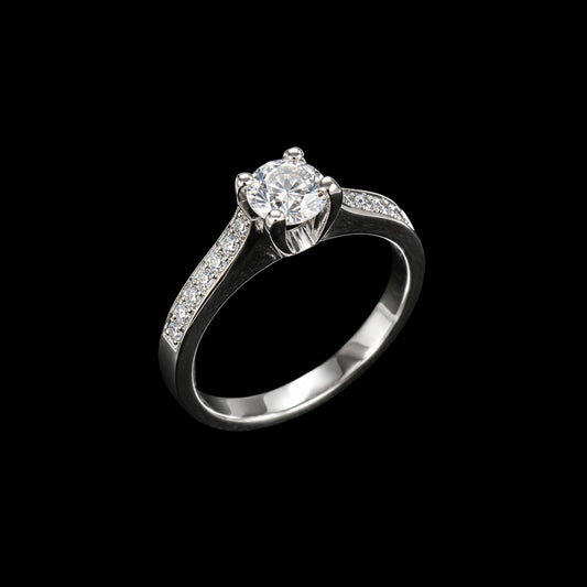 A silver ring with a round-cut cubic zirconia stone on a black background