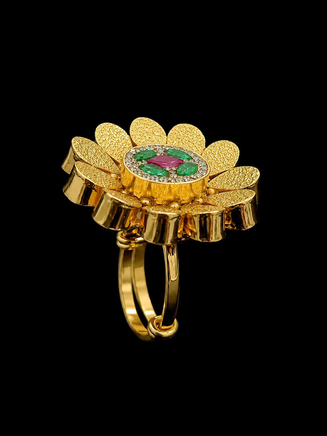 A gold ring with a flower design and CZ stones.