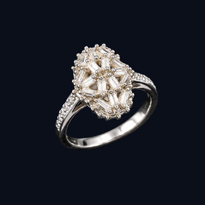 A silver ring with a flower-shaped design and clear cubic zirconia stones.