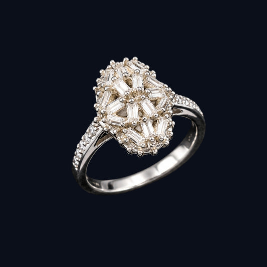 A silver ring with a flower-shaped design and clear cubic zirconia stones.