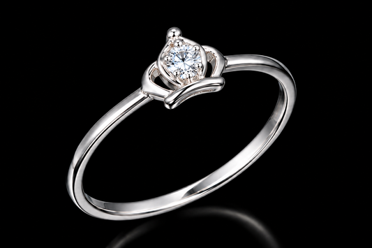A silver ring with a round-cut cubic zirconia stone on a black background.