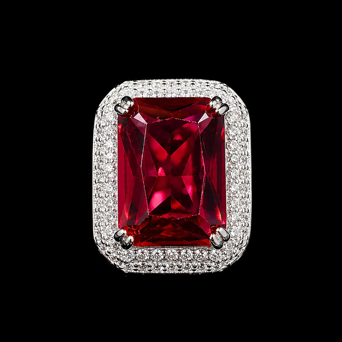 A silver-tone ring with a large, vibrant ruby red CZ stone.