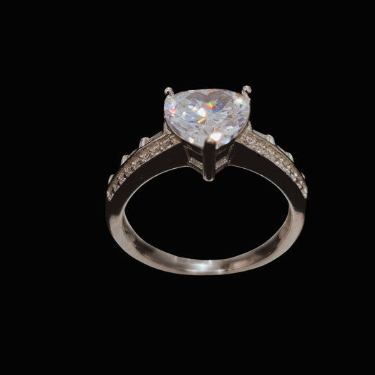 A silver ring with a heart-shaped CZ stone, set on a plain background.