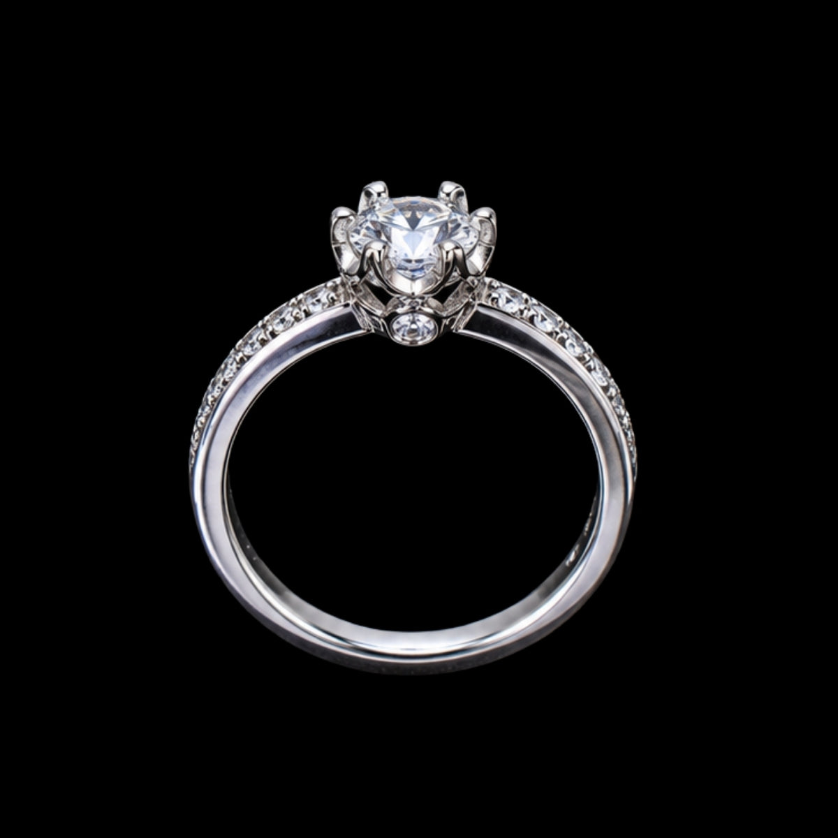 A silver-tone ring with a round-cut cubic zirconia stone at its center, surrounded by smaller stones on the band.