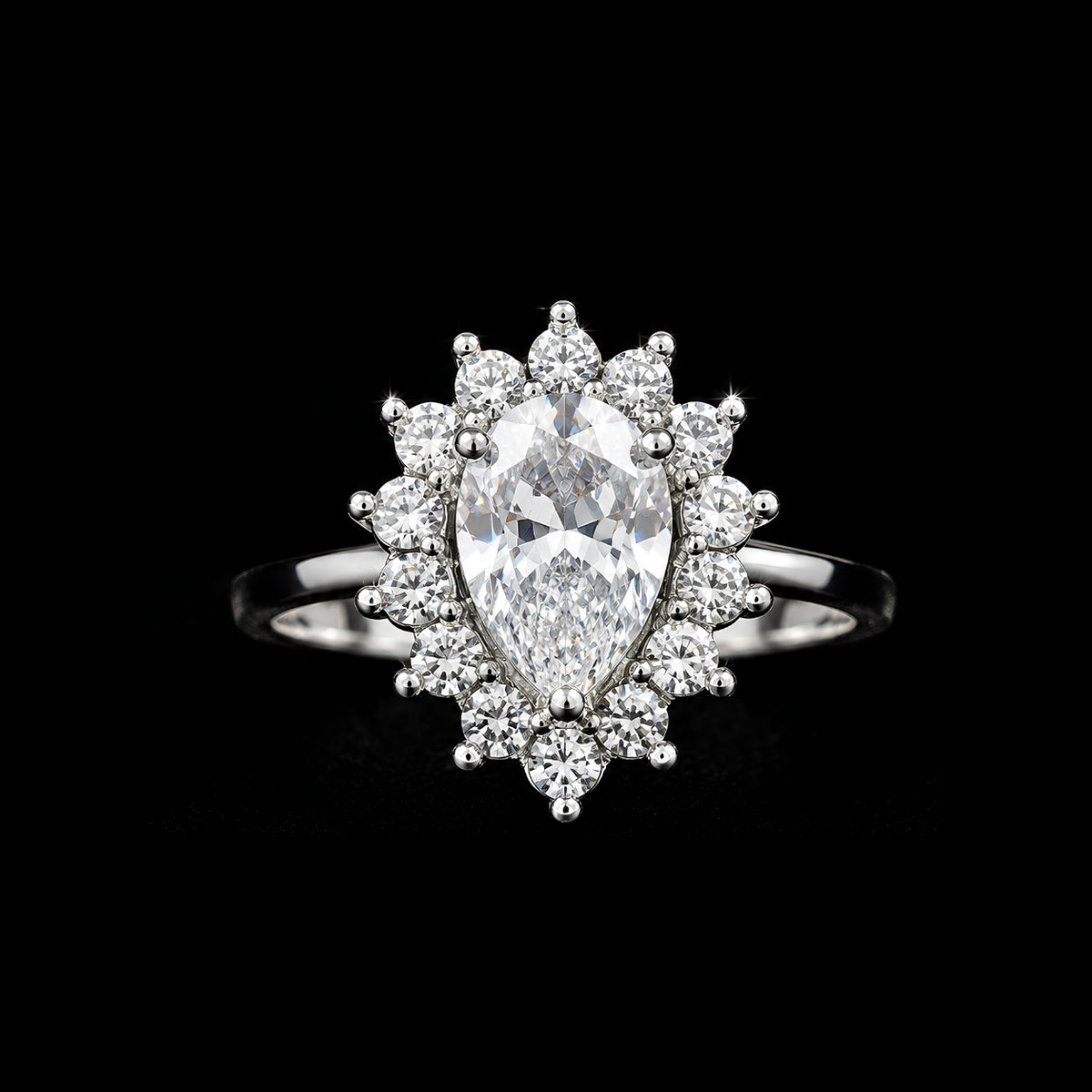 A pear-shaped ring with a large clear cubic zirconia stone and smaller stones set in silver-tone metal.