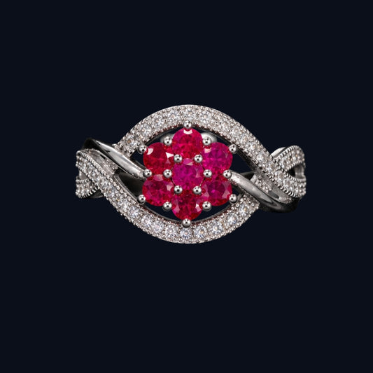 A silver-tone ring with a ruby flower design and CZ stones