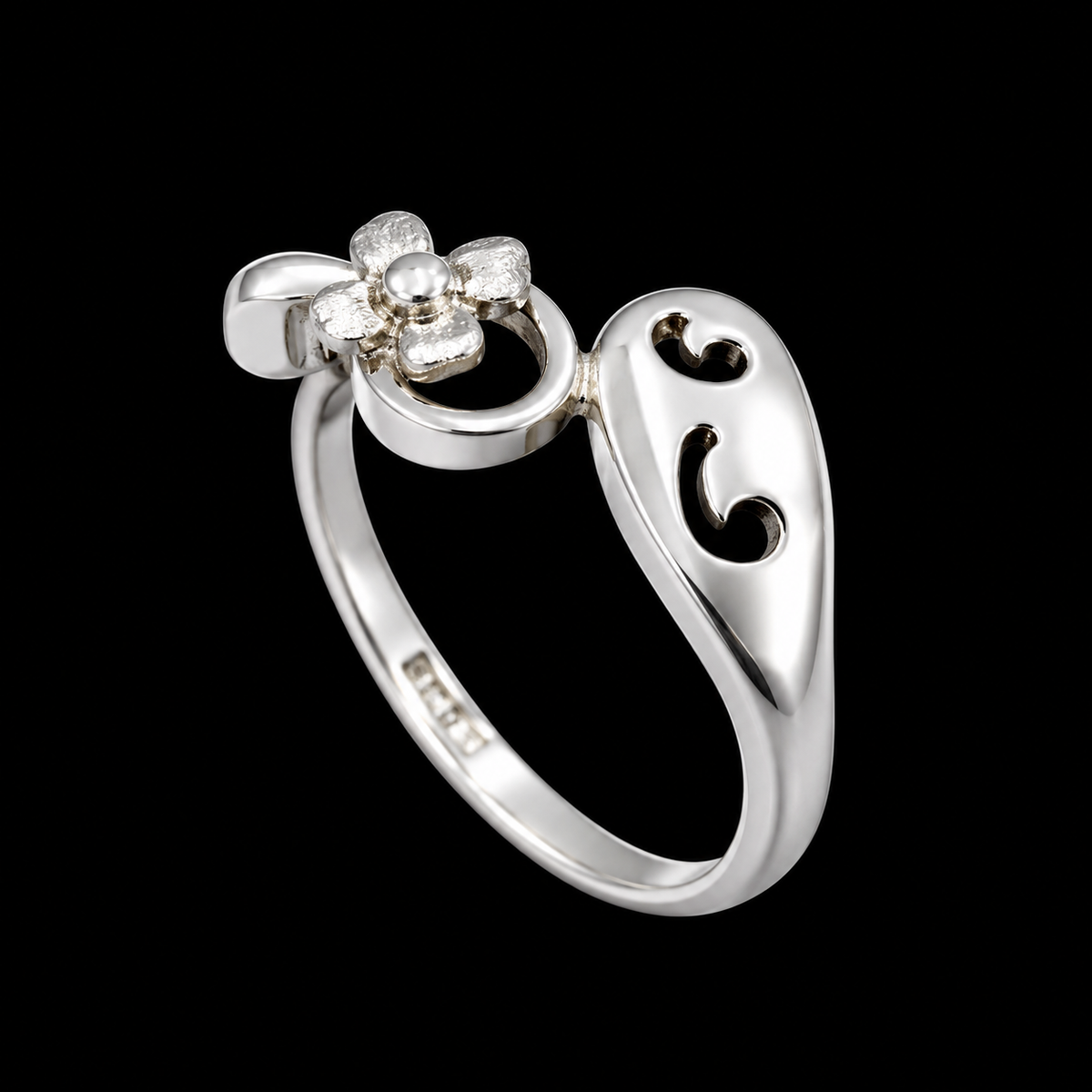 A silver ring with a flower design and a pearl at its center.