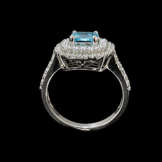 A silver ring with a blue gemstone and clear stones on a black background