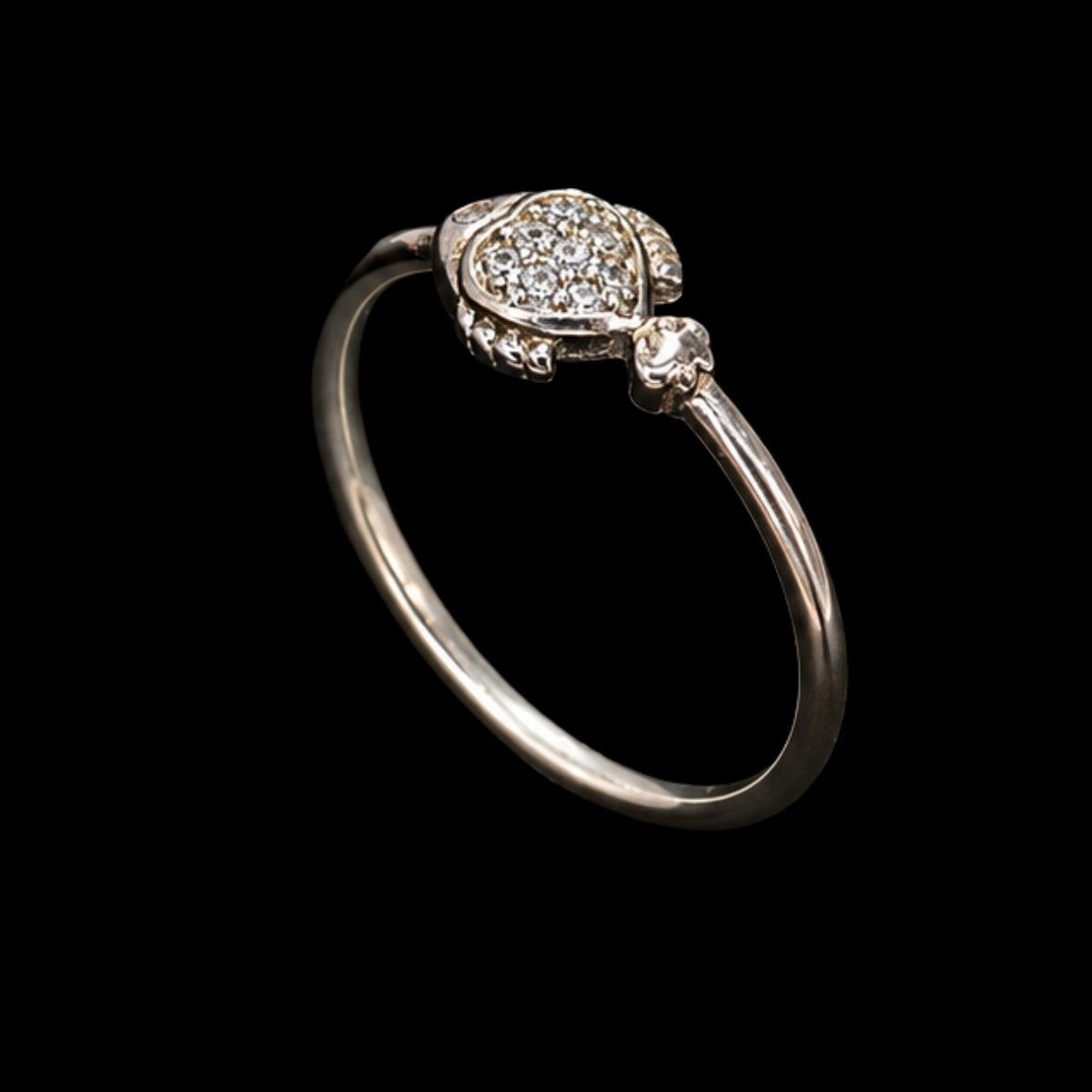 A silver ring with enamel work and CZ stones on a plain background