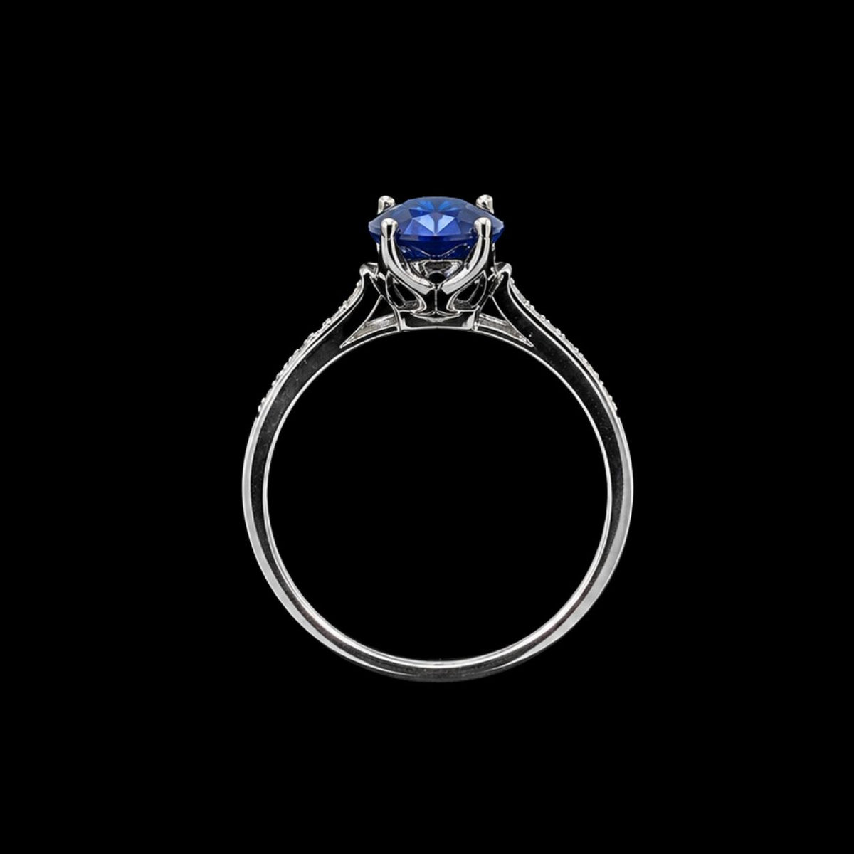 A silver-tone ring with a round-cut blue CZ stone set in a minimalist design.
