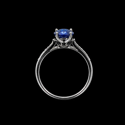 A silver-tone ring with a round-cut blue CZ stone set in a minimalist design.