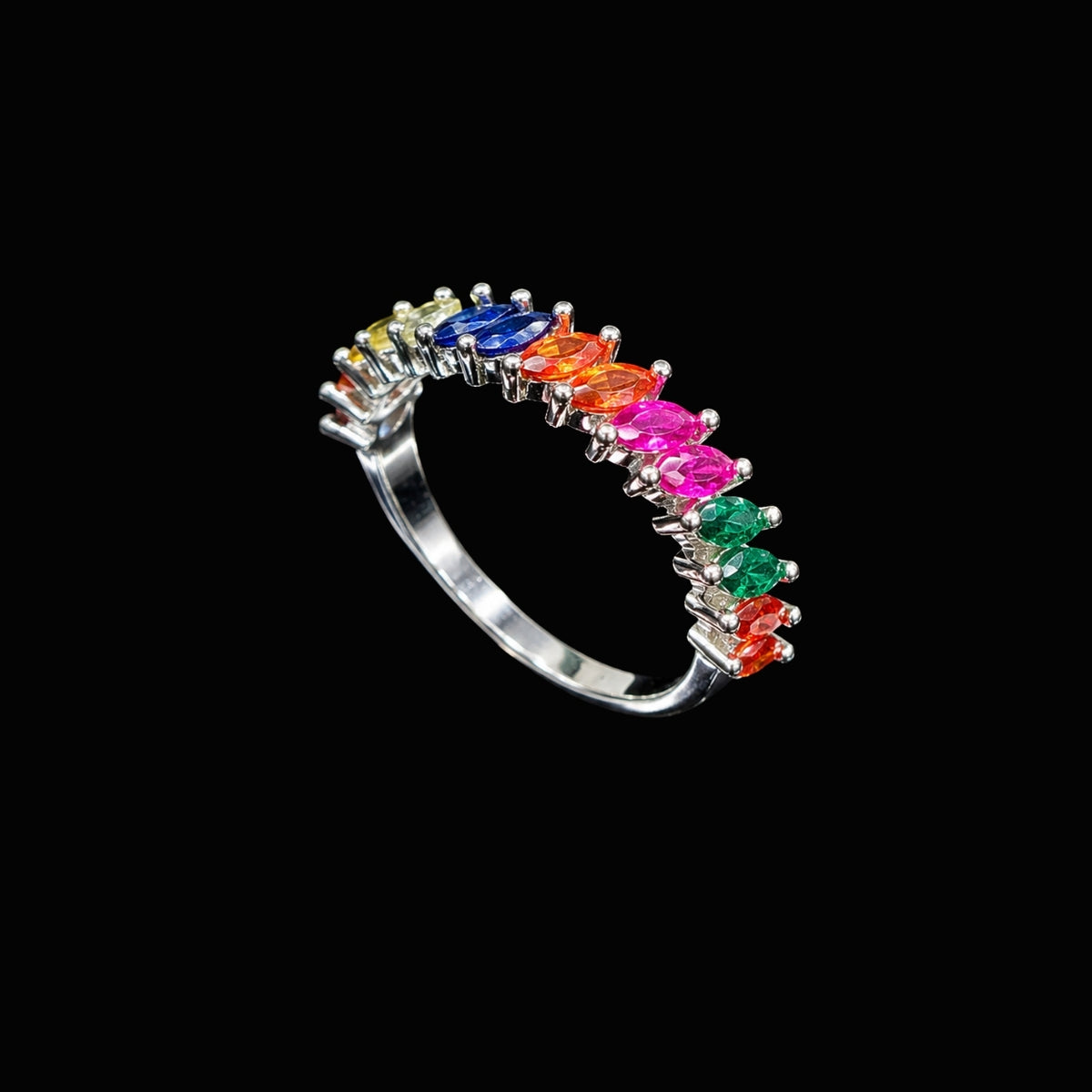A silver ring with a row of colorful CZ stones on a black background.
