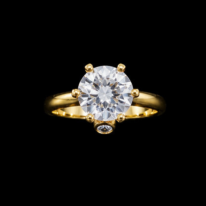 A gold-tone ring with a round-cut cubic zirconia stone, set in a classic solitaire design.