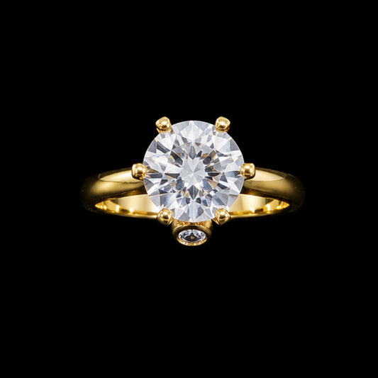 A gold-tone ring with a round-cut cubic zirconia stone, set in a classic solitaire design.
