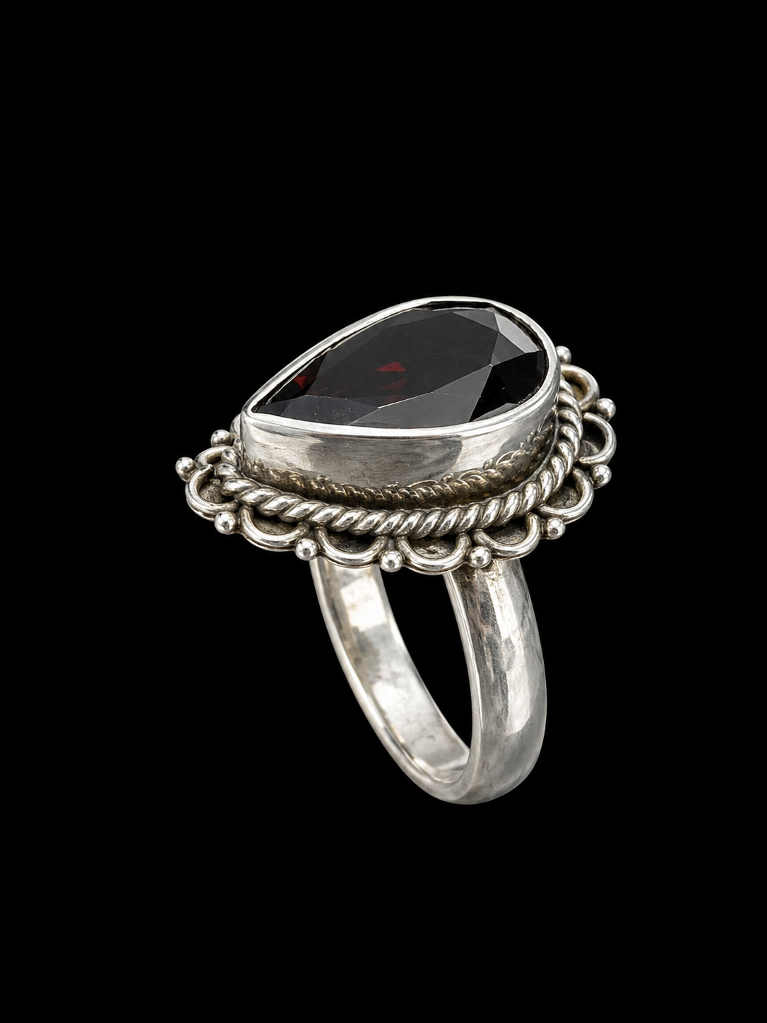 A black CZ ring with a large stone set in a silver-tone setting.