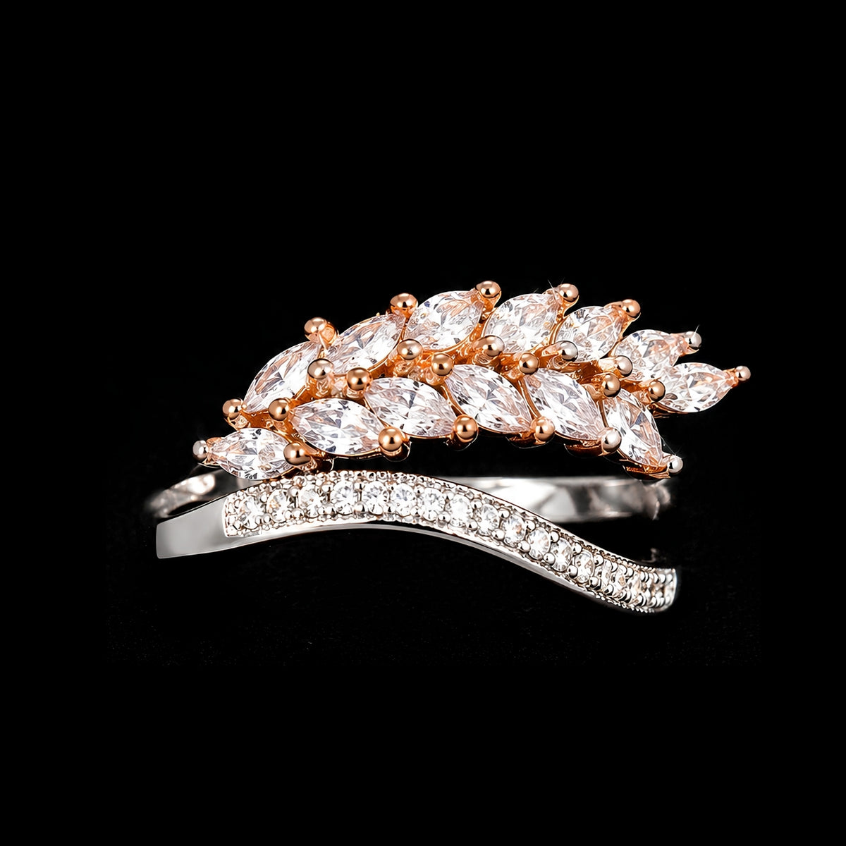 A rose gold ring with clear CZ stones arranged in a leaf-inspired design.