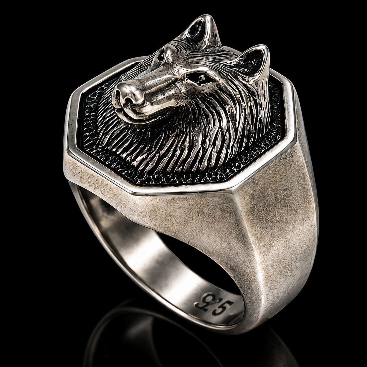 A silver ring with a detailed wolf head design on a black background.