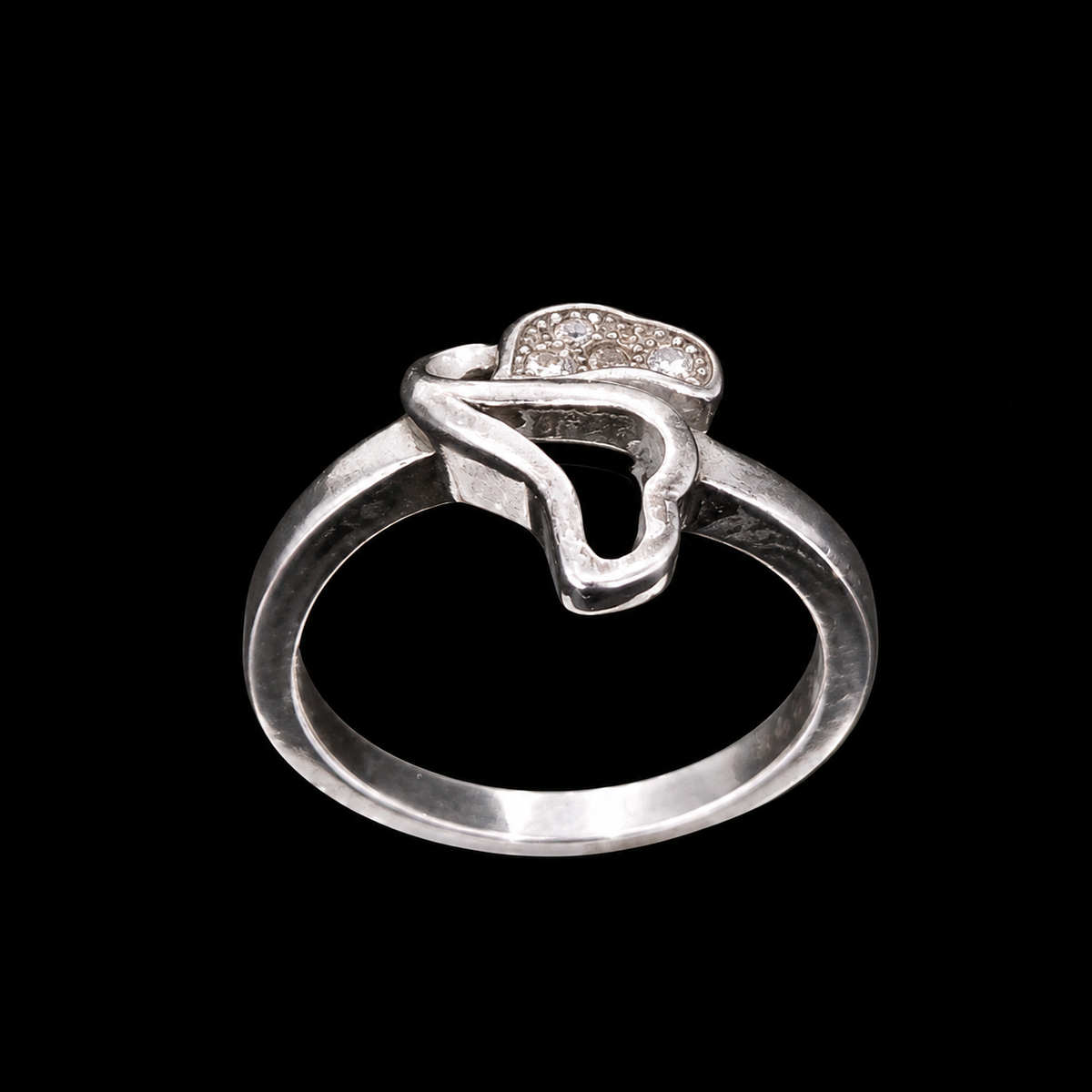 A silver ring with a CZ stone motif.
