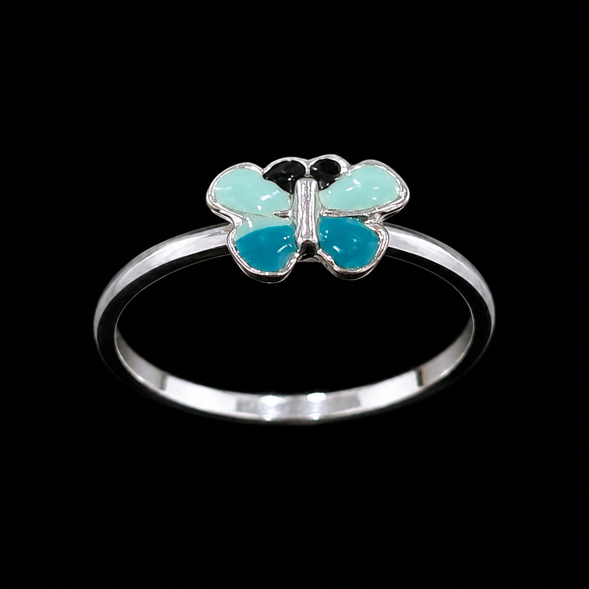 A silver ring with a butterfly motif and blue and green enamel details.