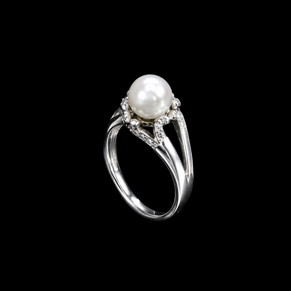 A silver-tone ring with a pearl and CZ stones on a black background.