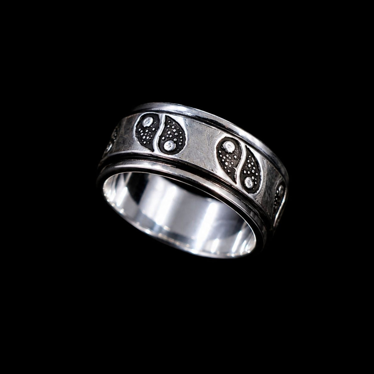 A silver band with a paisley design and CZ stones