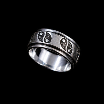 A silver band with a paisley design and CZ stones