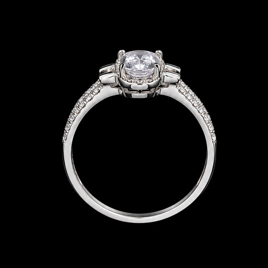 A silver ring with a round-cut CZ stone on a black background