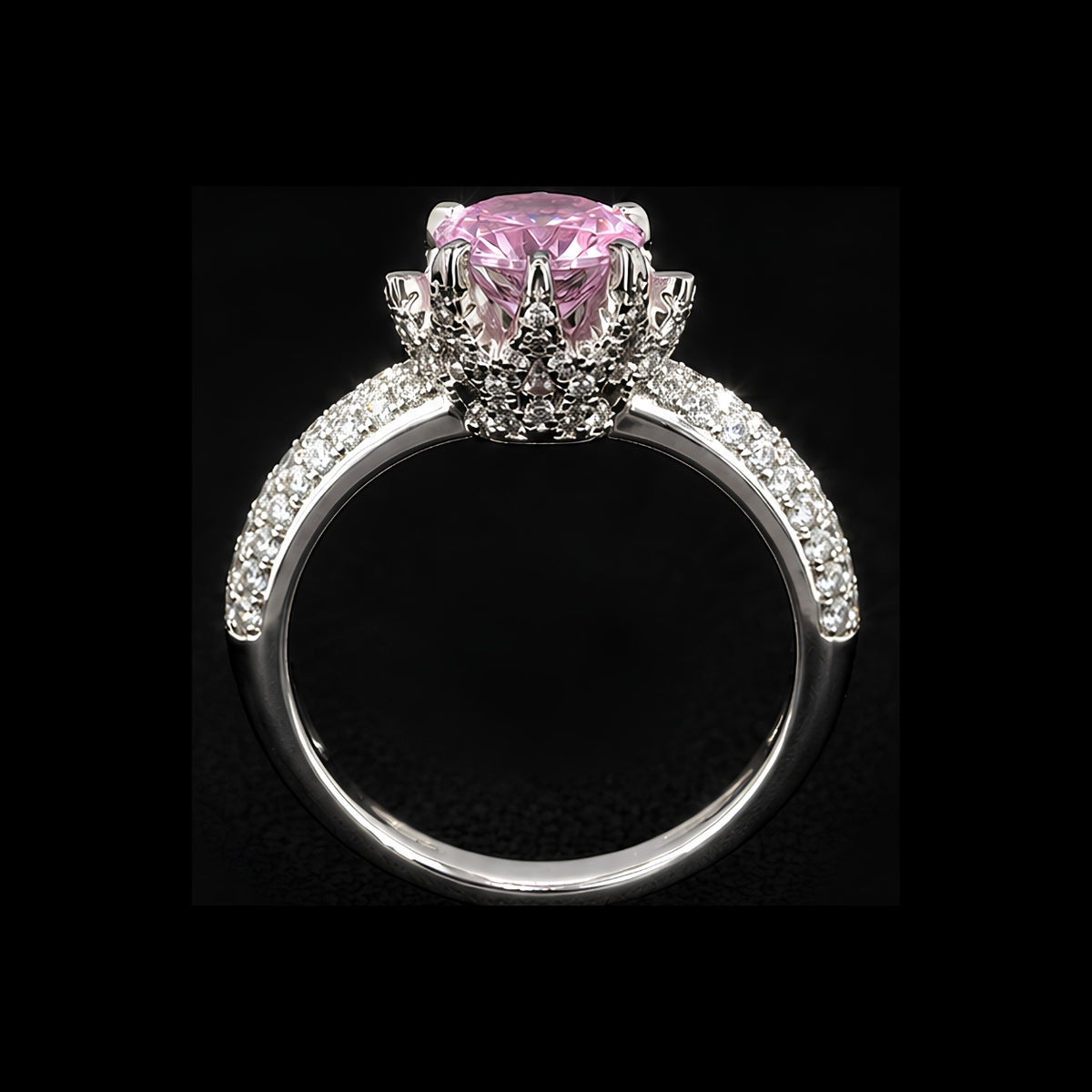 A silver-tone ring with a large pink CZ stone and smaller clear stones, set in a delicate filigree design.