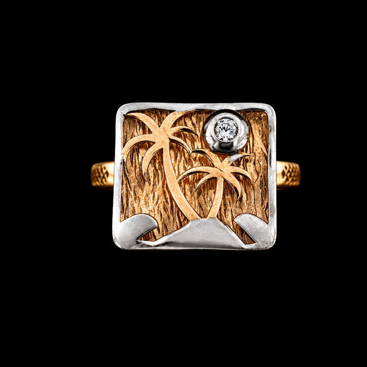 A gold-tone and silver-tone ring with a tropical island design and CZ stone.