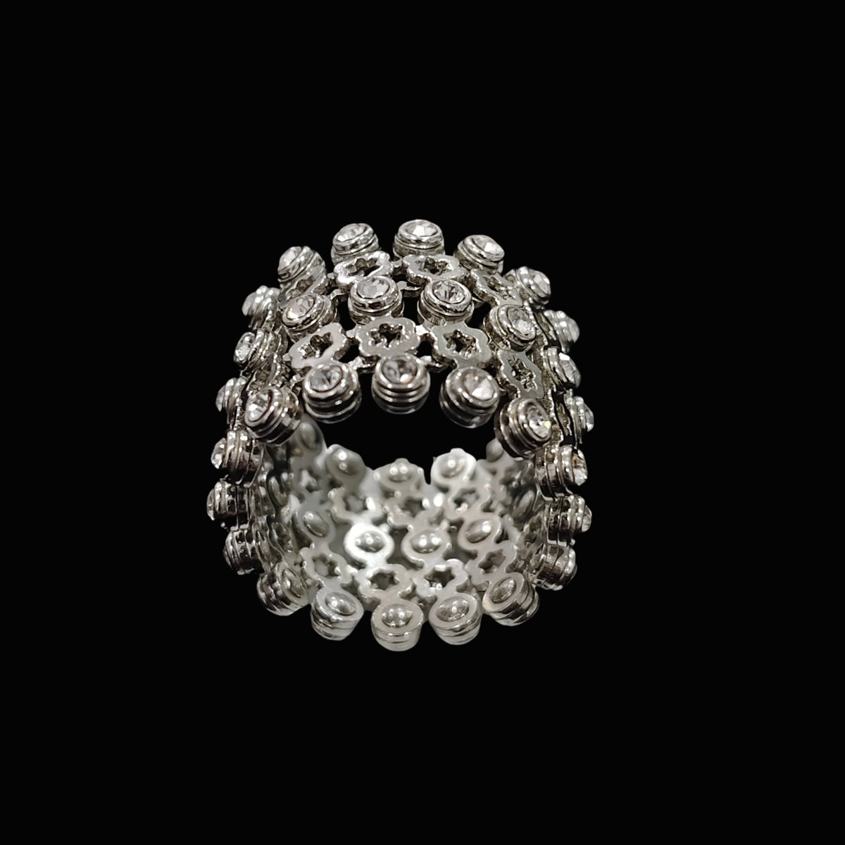 A silver ring with intricate details and sparkling CZ stones.