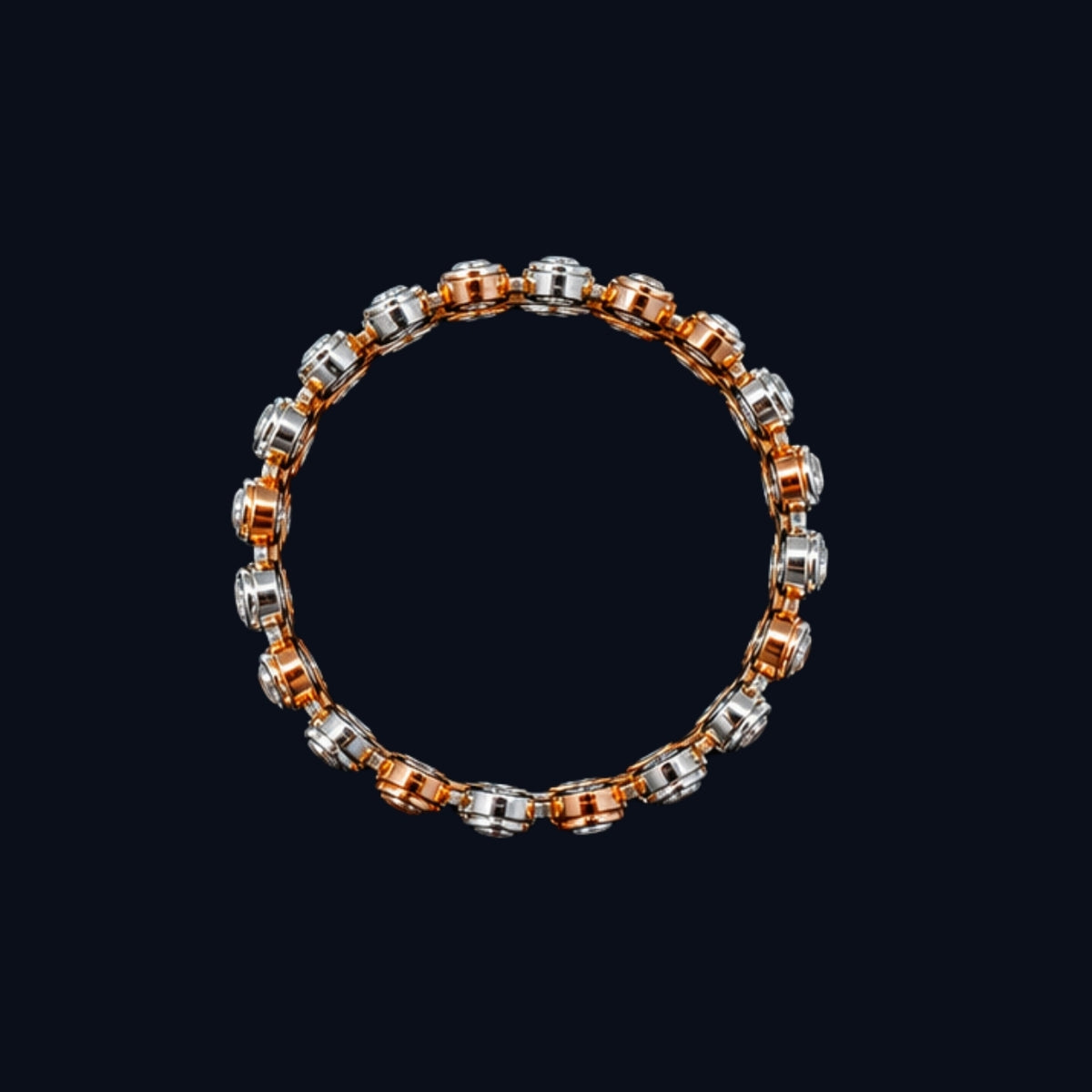A gold and silver tone chain bracelet with a mix of round and oval links.