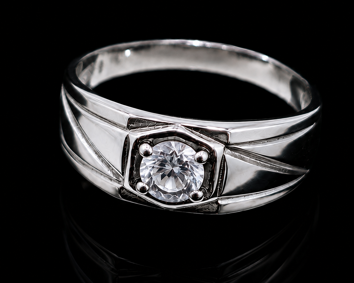 A silver ring with a round-cut CZ stone in the center, set against a dark background.