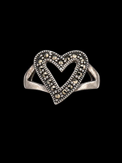 A silver ring with a heart-shaped design and clear CZ stones.