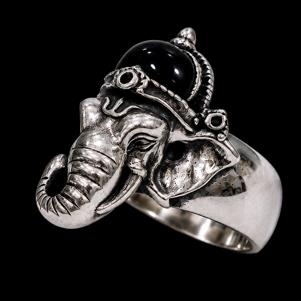A silver ring with an elephant design and a black stone in the center.