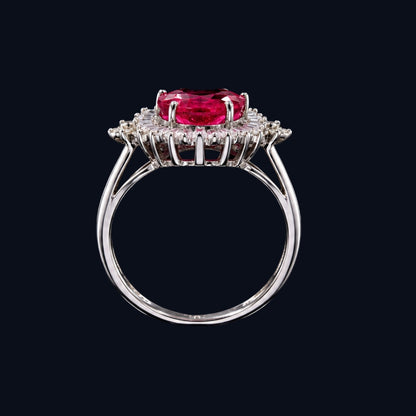 A silver-tone ring featuring an oval-cut ruby and clear cubic zirconia stones.