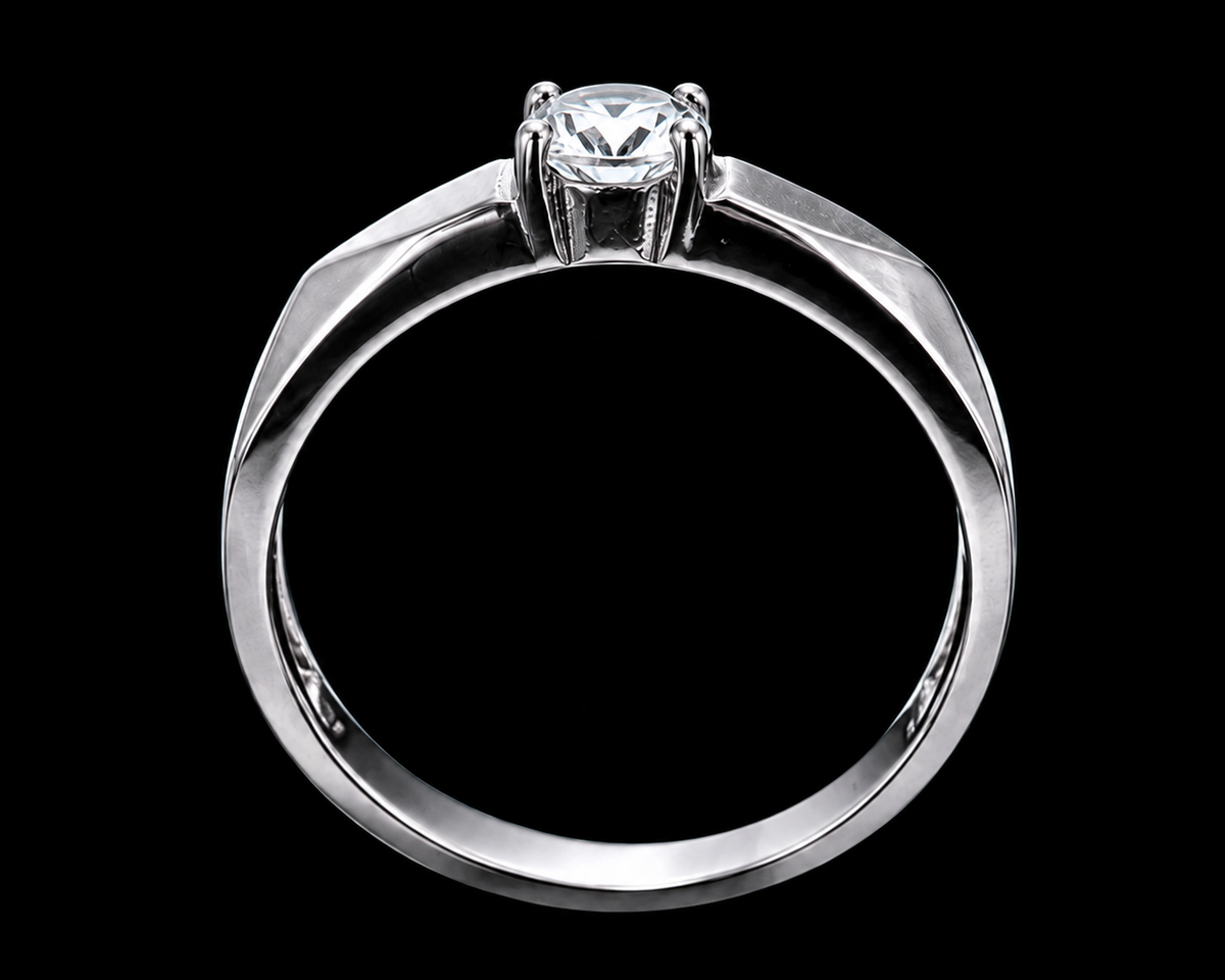 A silver ring with a round-cut CZ stone on a plain background.