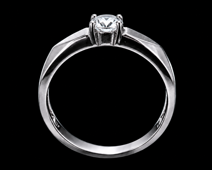 A silver ring with a round-cut CZ stone on a plain background.