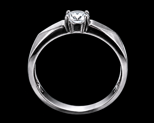 A silver ring with a round-cut CZ stone on a plain background.
