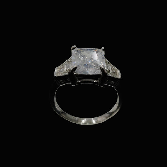 A square-cut CZ stone is set in a silver-tone setting, with a sleek and modern design.