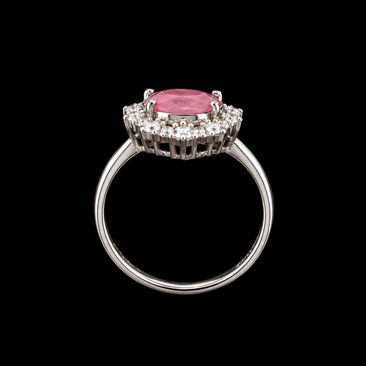A silver-tone ring with a pink CZ stone and clear CZ stones around it.