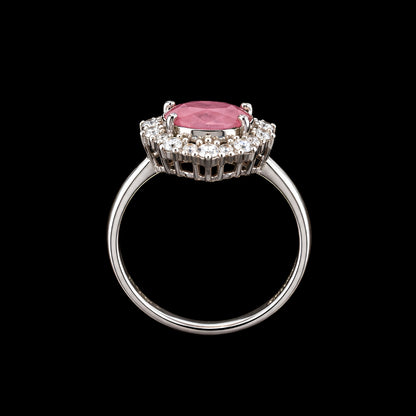 A silver-tone ring with a pink CZ stone and clear CZ stones around it.