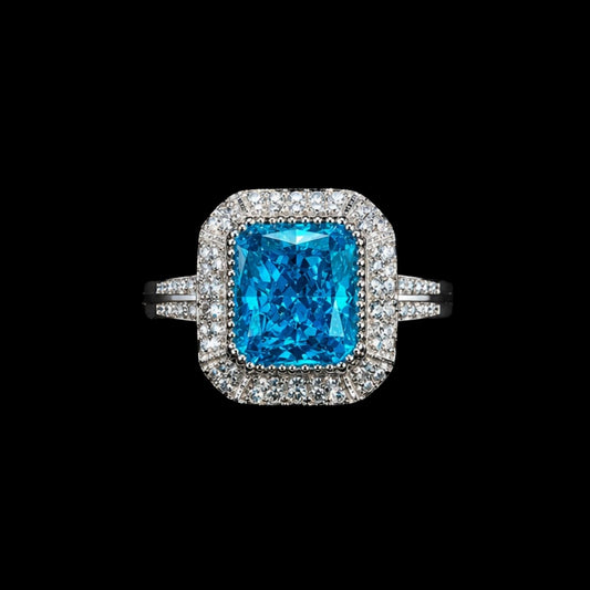 A silver ring with a large blue gemstone and smaller clear gemstones