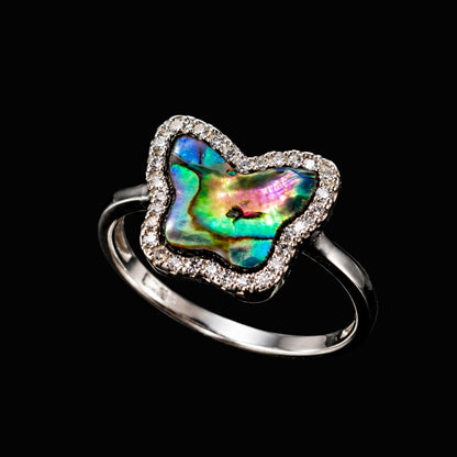 A silver ring with a butterfly-shaped abalone shell and CZ stones.
