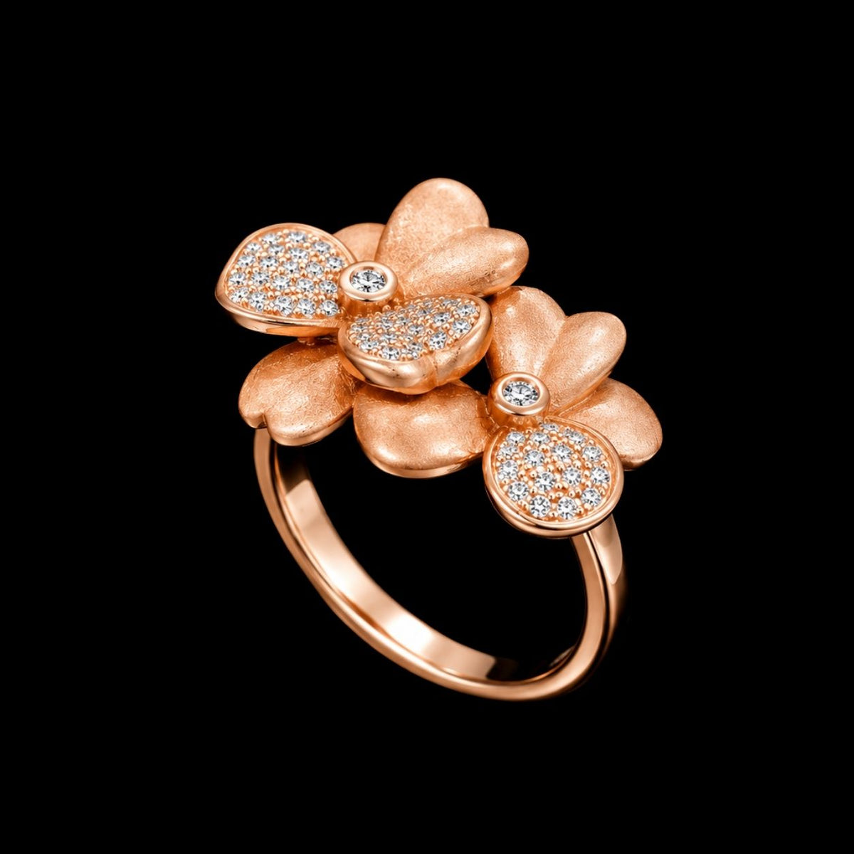 A rose gold ring with a floral design and cubic zirconia stones.