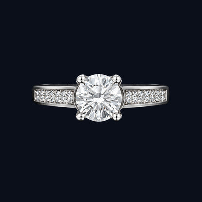 A silver ring with a round-cut CZ stone in the center, set on a delicate band.