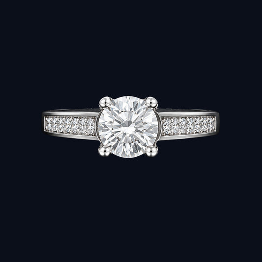 A silver ring with a round-cut CZ stone in the center, set on a delicate band.