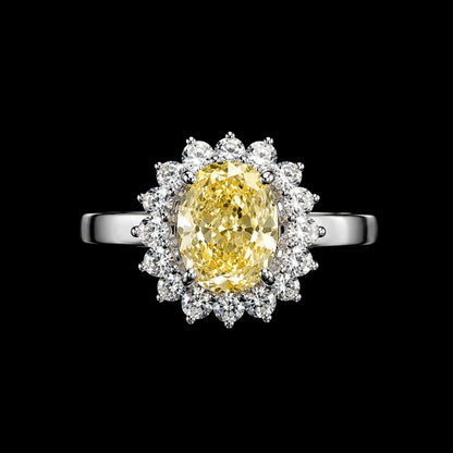 A silver ring with a yellow CZ stone and clear CZ stones surrounding it.